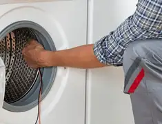 Dryer repair technician diagnosing and servicing a clothes dryer in Long Beach, CA