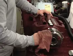 Vacuum repair technician cleaning and servicing a vacuum motor in Long Beach, CA